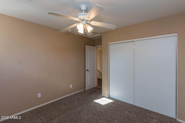 unfurnished bedroom featuring ceiling fan, carpet flooring, and a closet