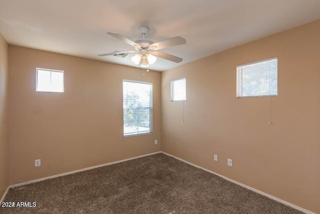 carpeted empty room with plenty of natural light and ceiling fan