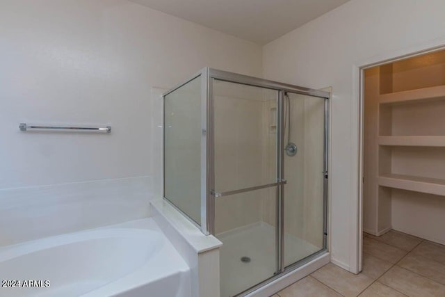 bathroom featuring plus walk in shower and tile patterned floors