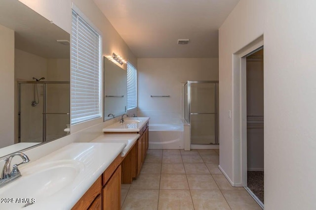 bathroom featuring tile patterned flooring, shower with separate bathtub, and vanity