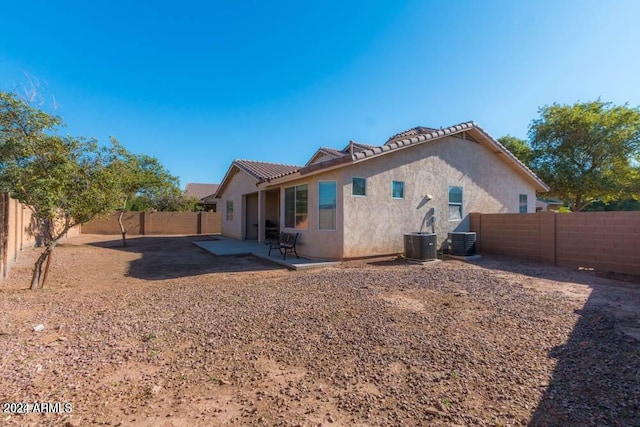 rear view of property featuring a patio area and central air condition unit