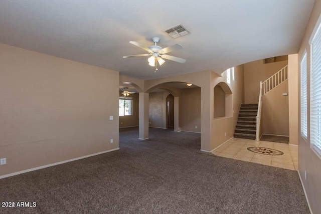 unfurnished room featuring ceiling fan and light carpet