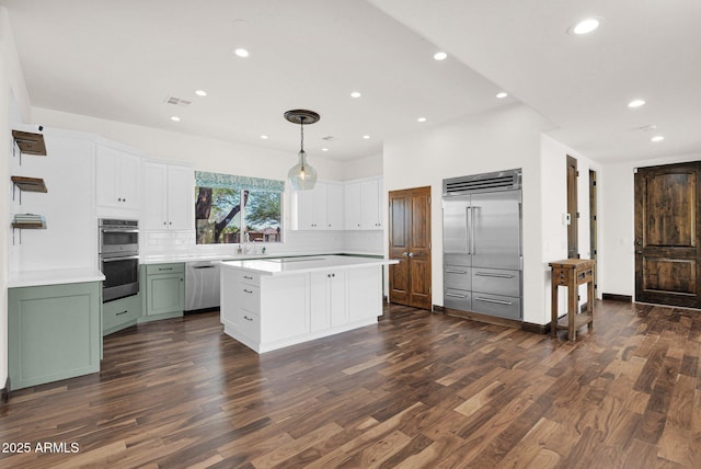 6310 E Dove Valley Rd, Cave Creek, AZ 85331 - kitchen with appliances with stainless steel finishes, tasteful backsplash, a center island, dark wood-style floors, and light countertops