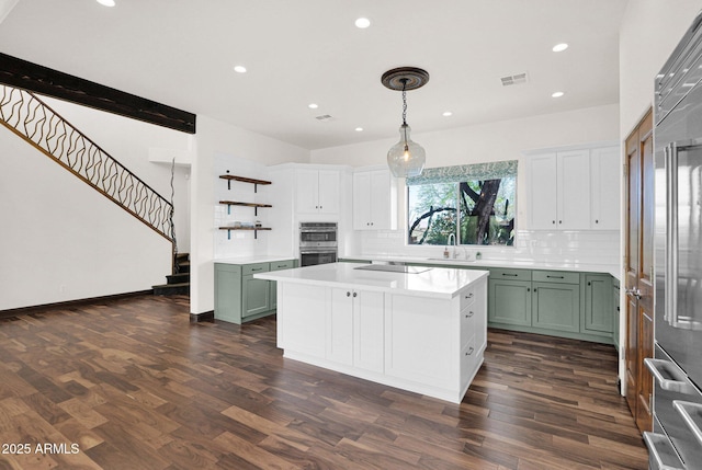 6310 E Dove Valley Rd, Cave Creek, AZ 85331 - kitchen with green cabinets, tasteful backsplash, stainless steel double oven, light countertops, and recessed lighting