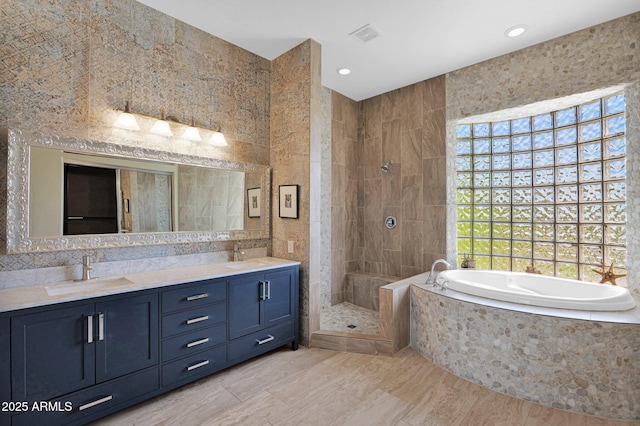 6310 E Dove Valley Rd, Cave Creek, AZ 85331 - bathroom featuring a tile shower, a bath, double vanity, tile walls, and recessed lighting