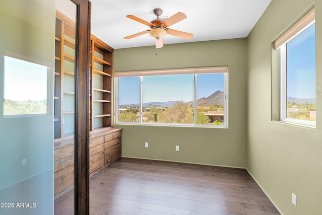6310 E Dove Valley Rd, Cave Creek, AZ 85331 - unfurnished room with wood finished floors, a ceiling fan, and a mountain view