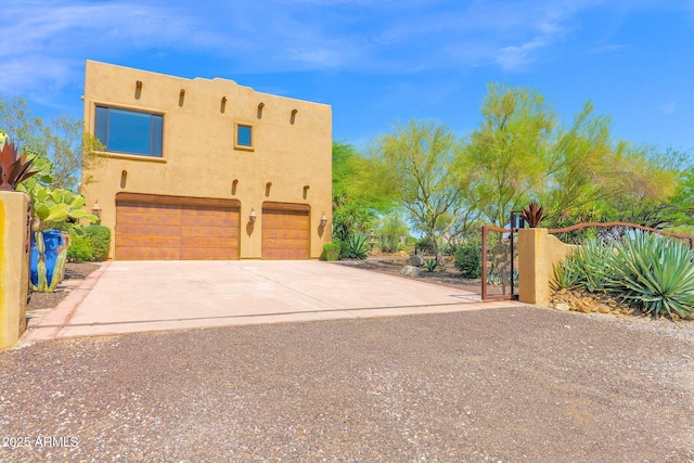 6310 E Dove Valley Rd, Cave Creek, AZ 85331 - view of side of property featuring an attached garage, stucco siding, driveway, and a gate