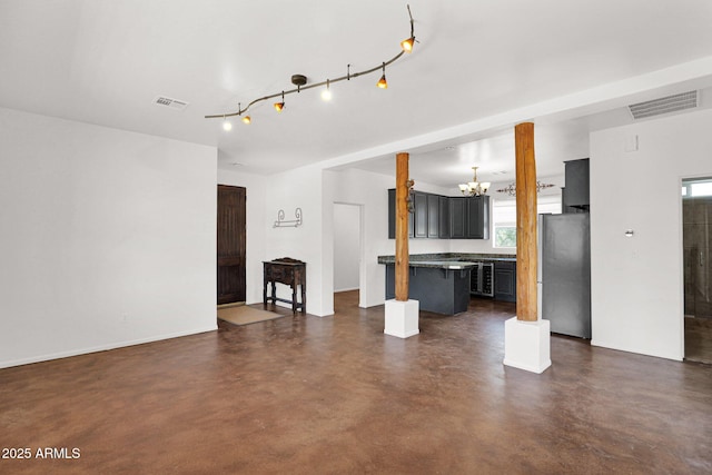 6310 E Dove Valley Rd, Cave Creek, AZ 85331 - unfurnished living room featuring a chandelier and finished concrete flooring