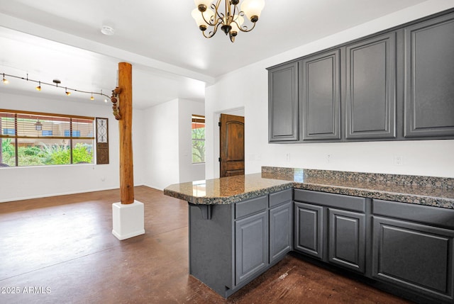 6310 E Dove Valley Rd, Cave Creek, AZ 85331 - kitchen with a peninsula, gray cabinetry, plenty of natural light, and a chandelier