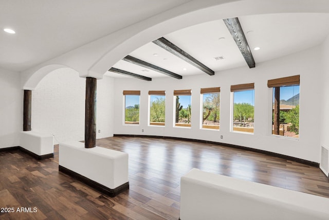 6310 E Dove Valley Rd, Cave Creek, AZ 85331 - living room with healthy amount of natural light, arched walkways, beam ceiling, dark wood finished floors, and recessed lighting