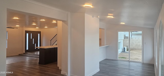 hall featuring dark wood-style floors, vaulted ceiling, and a wealth of natural light