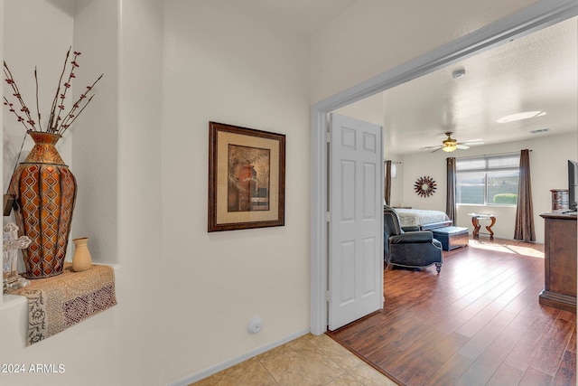 hallway with hardwood / wood-style flooring