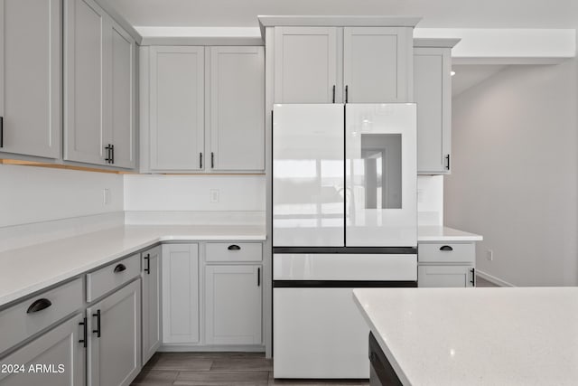 kitchen with light countertops, fridge, and light wood-style flooring