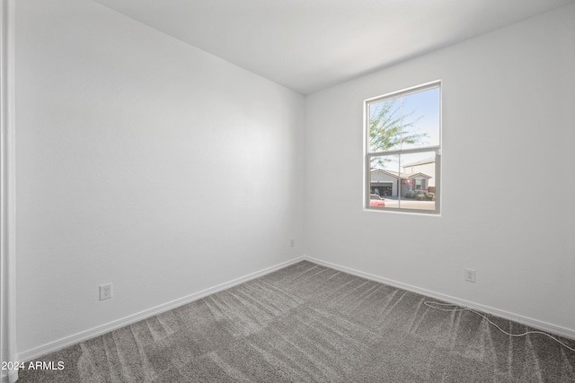 carpeted empty room with baseboards