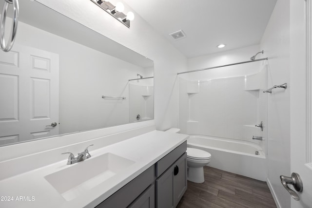 bathroom featuring visible vents, toilet, vanity, wood finished floors, and shower / bathtub combination