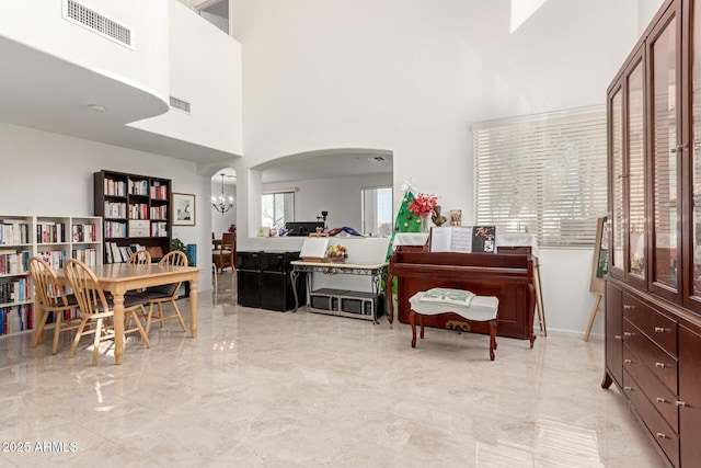 interior space featuring a high ceiling and an inviting chandelier