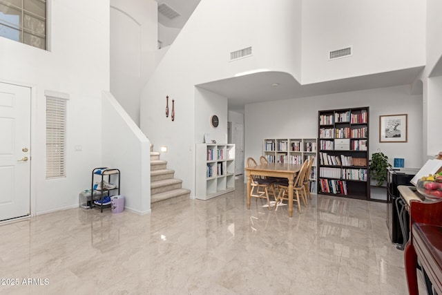 dining room with a towering ceiling