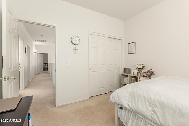 carpeted bedroom with a closet