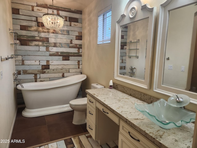 bathroom with a tub, tile patterned flooring, toilet, and vanity