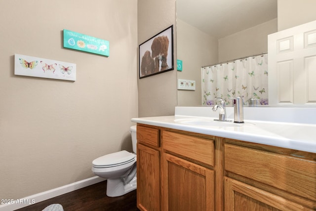 bathroom featuring toilet, vanity, and hardwood / wood-style floors