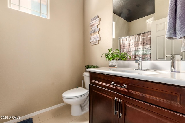 bathroom featuring tile patterned flooring, vanity, toilet, and walk in shower