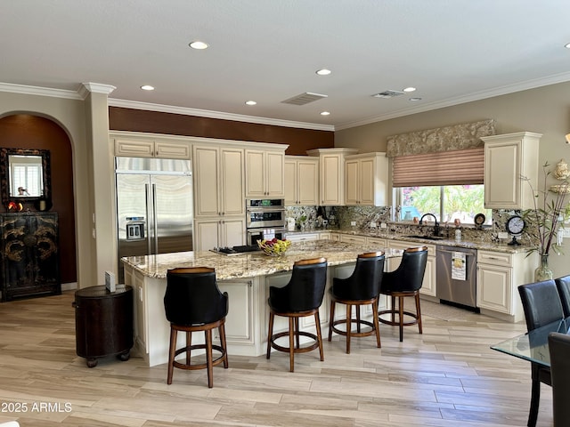 562 E Vesper Trl, Queen Creek, AZ 85140 - kitchen featuring appliances with stainless steel finishes, a center island, tasteful backsplash, a sink, and light stone countertops