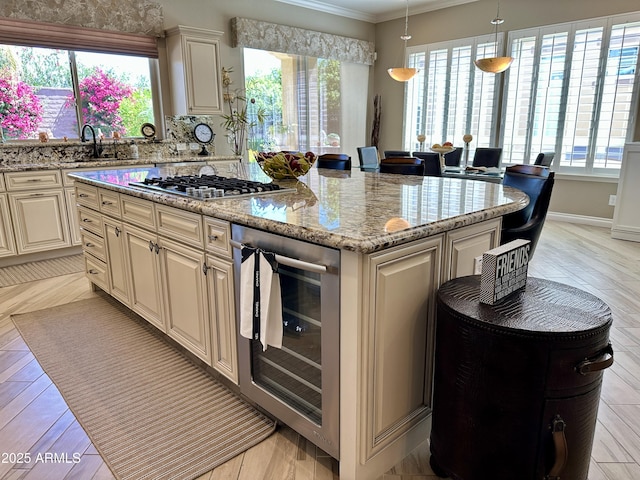 562 E Vesper Trl, Queen Creek, AZ 85140 - kitchen featuring wine cooler, stainless steel gas cooktop, a kitchen island, a sink, and healthy amount of natural light