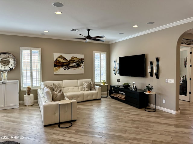 562 E Vesper Trl, Queen Creek, AZ 85140 - living area featuring arched walkways, a ceiling fan, light wood-style flooring, ornamental molding, and baseboards