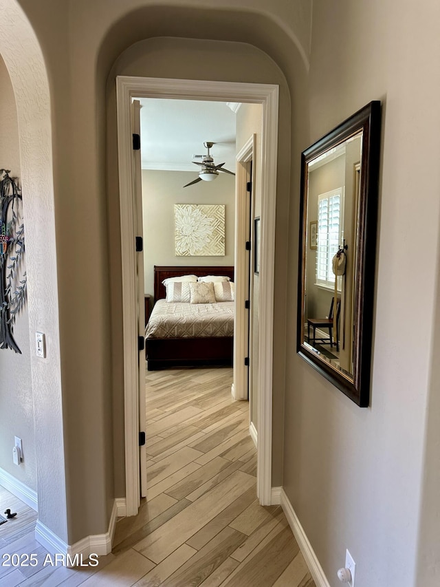562 E Vesper Trl, Queen Creek, AZ 85140 - hall with arched walkways, light wood-style floors, and baseboards