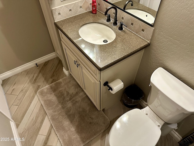 562 E Vesper Trl, Queen Creek, AZ 85140 - bathroom featuring vanity, wood finished floors, a textured wall, toilet, and baseboards