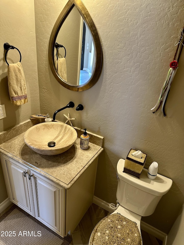 562 E Vesper Trl, Queen Creek, AZ 85140 - half bathroom featuring vanity, toilet, and baseboards