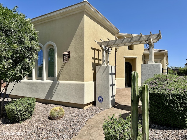 562 E Vesper Trl, Queen Creek, AZ 85140 - view of property exterior featuring stucco siding and a pergola