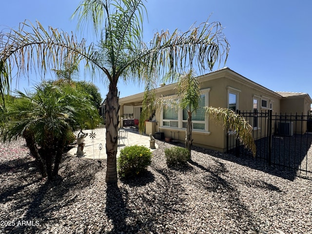 562 E Vesper Trl, Queen Creek, AZ 85140 - view of home's exterior with a patio area, stucco siding, and central AC