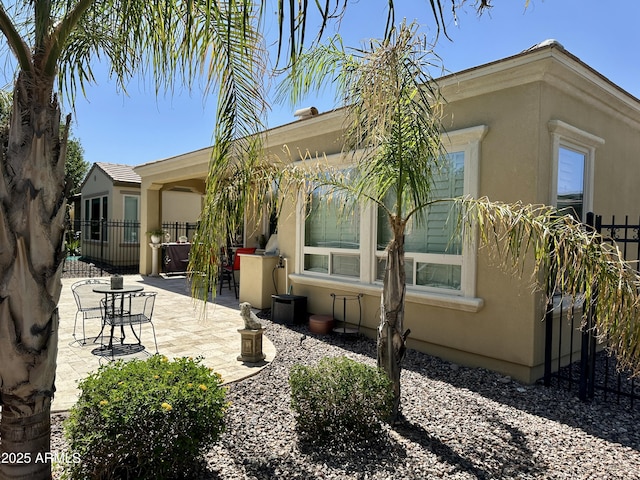 562 E Vesper Trl, Queen Creek, AZ 85140 - rear view of house featuring stucco siding and a patio