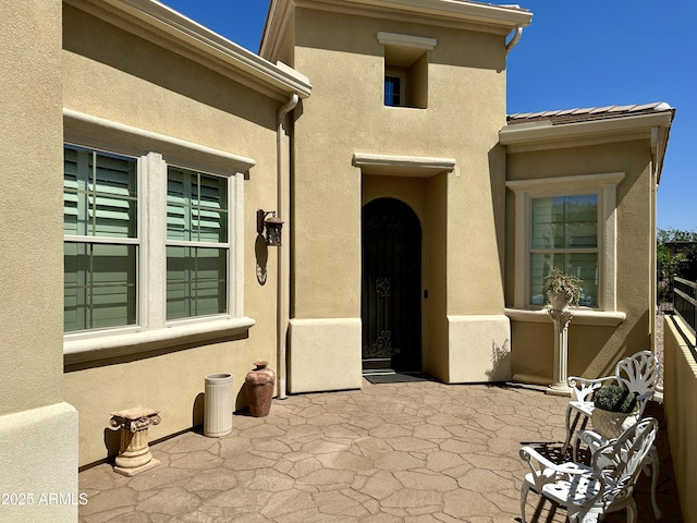 562 E Vesper Trl, Queen Creek, AZ 85140 - view of exterior entry with stucco siding and a patio