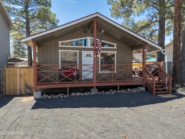 view of front of home featuring a wooden deck and fence