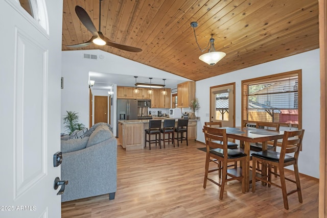 dining area with vaulted ceiling, ceiling fan, light wood finished floors, wooden ceiling, and visible vents