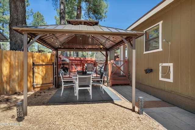 view of patio / terrace featuring fence and a gazebo