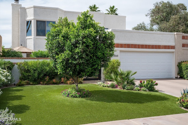 8068 E Del Trigo Rd, Scottsdale, AZ 85258 - view of front of house featuring stucco siding, driveway, a front lawn, and an attached garage