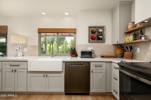 8068 E Del Trigo Rd, Scottsdale, AZ 85258 - kitchen featuring stainless steel dishwasher, electric stove, plenty of natural light, light countertops, and recessed lighting