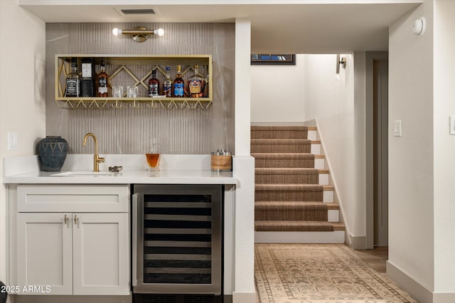 8068 E Del Trigo Rd, Scottsdale, AZ 85258 - indoor wet bar with wine cooler and stairway