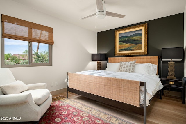 8068 E Del Trigo Rd, Scottsdale, AZ 85258 - bedroom featuring wood finished floors and a ceiling fan