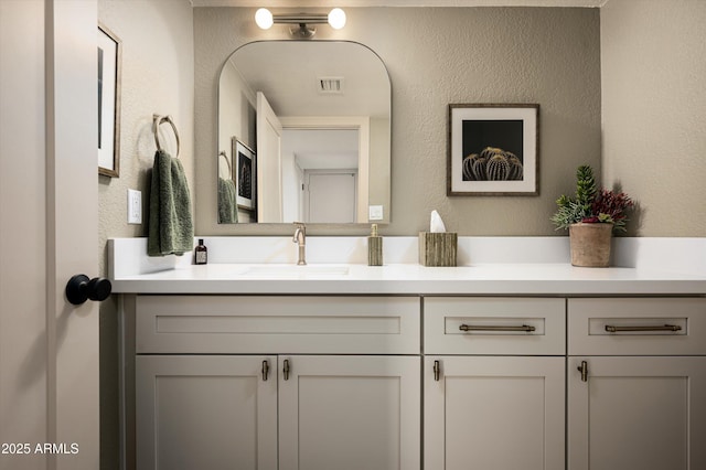 8068 E Del Trigo Rd, Scottsdale, AZ 85258 - bathroom with vanity and a textured wall