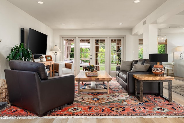 8068 E Del Trigo Rd, Scottsdale, AZ 85258 - living room with wood finished floors, recessed lighting, a chandelier, and french doors