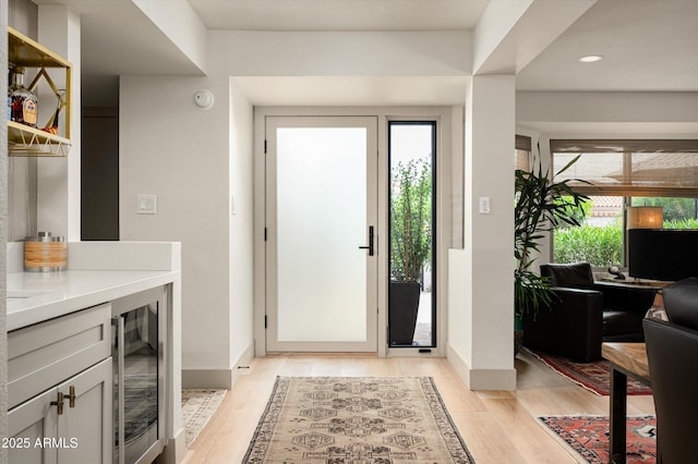8068 E Del Trigo Rd, Scottsdale, AZ 85258 - foyer featuring wine cooler, plenty of natural light, light wood-style floors, and recessed lighting