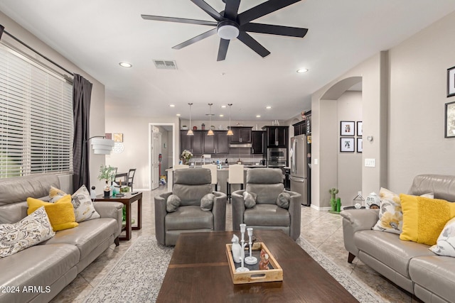 living room with ceiling fan and light tile patterned flooring