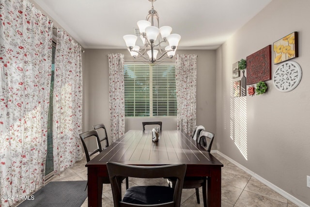 tiled dining space featuring a notable chandelier