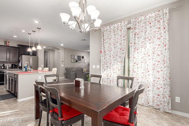 tiled dining space with an inviting chandelier