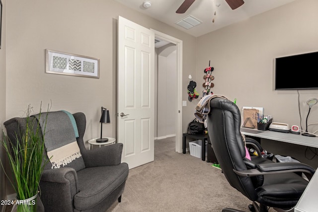 carpeted home office featuring ceiling fan