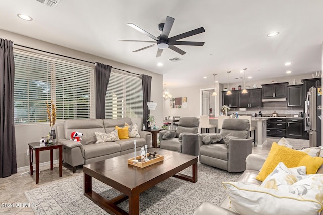 living room featuring ceiling fan and light tile patterned floors